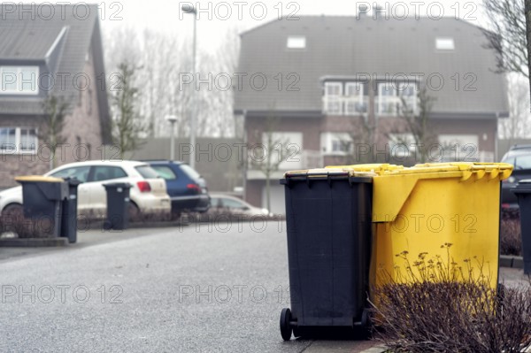 Yellow and grey bins in a residential area
