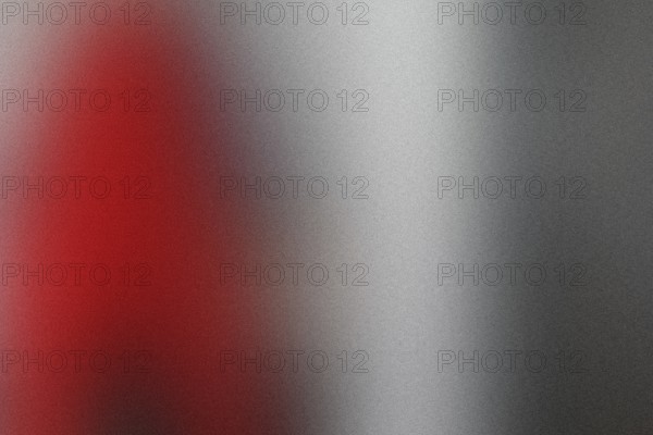 Red object is in the background of a gray photo