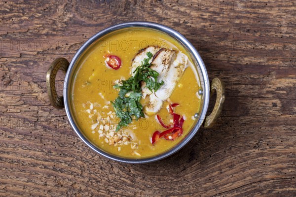 Indian mulligatawny soup in a bowl of brass