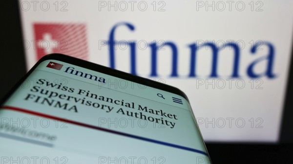 Stuttgart, Germany, 06-04-2022: Mobile phone with website of Swiss Financial Market Supervisory Authority (FINMA) on screen in front of logo. Focus on top-left of phone display, Europe