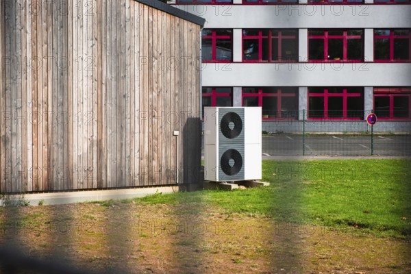 Two stacked heat pumps on a lawn in front of a house, Germany, Europe