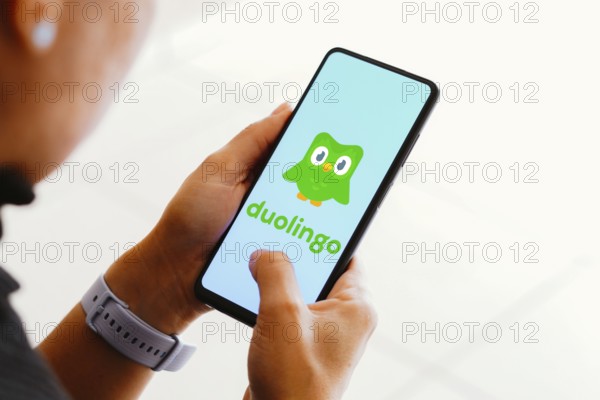 In this photo illustration, the Duolingo logo seen displayed on a smartphone