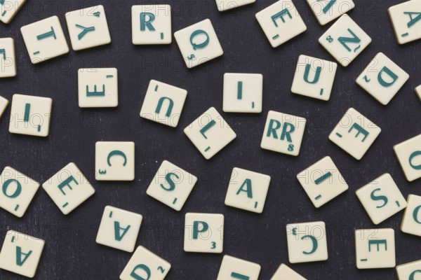Close up scrabble letters against black background. High resolution photo