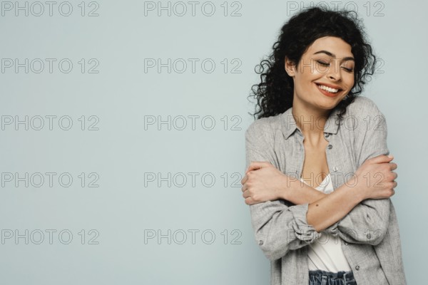 Medium shot woman hugging herself
