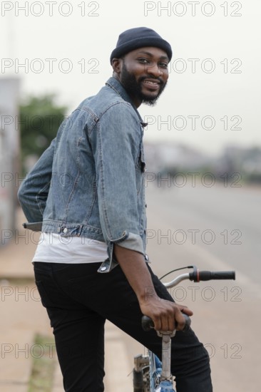 Medium shot man with bicycle posing