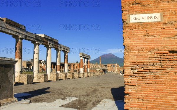 Ruins of Pompei or Pompeii with Vesuv in background with street sign in Latin in The Metropolitan City of Naples, Italy, Europe