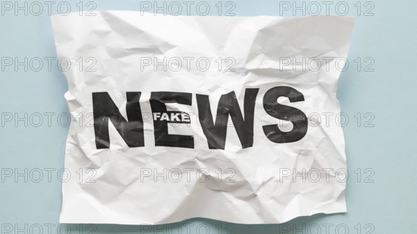 Top view fake news message crumbled paper