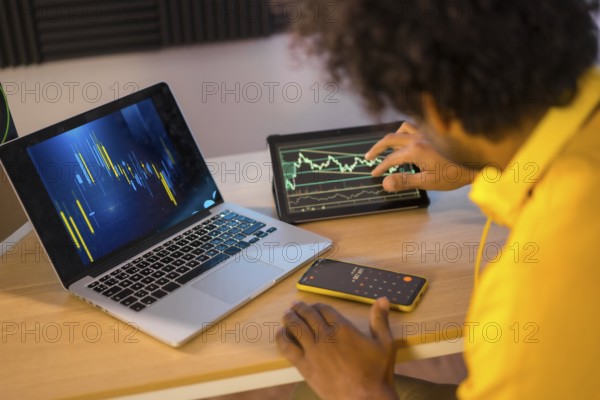Rear view of an unrecognizable businessman working in cryptocurrency from home office