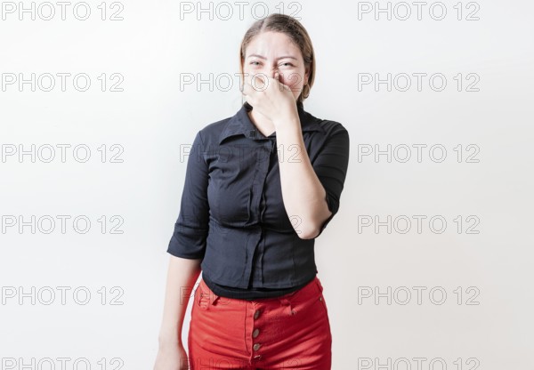 Displeased person holding her nose isolated. Disgust young girl covering nose. Woman covering nose from a bad smell isolated