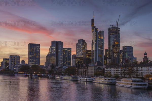The lights of Frankfurt's banking skyline begin to glow in the evening, Mainufer, Frankfurt am Main, Hesse, Germany, Europe