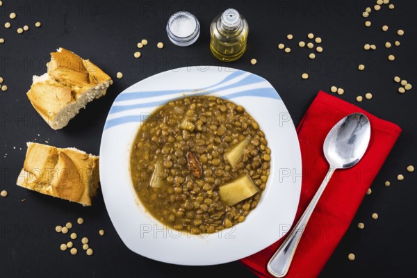 Homemade recipe of a finished Spanish lentil dish, ready to eat with bread