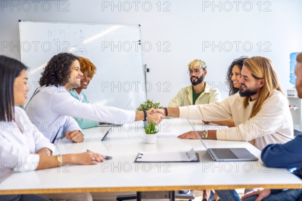 Men shaking hands during a meeting in a coworking