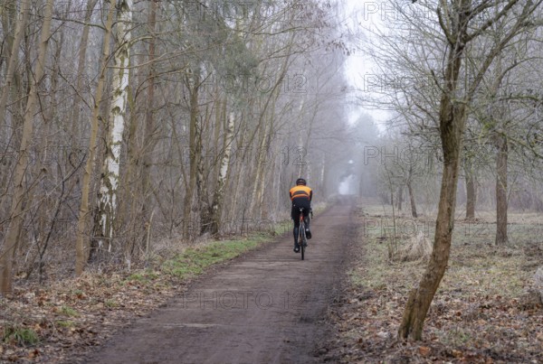 Cyclist, landscape photography, fog in January, Berlin Lübars, Germany, Europe