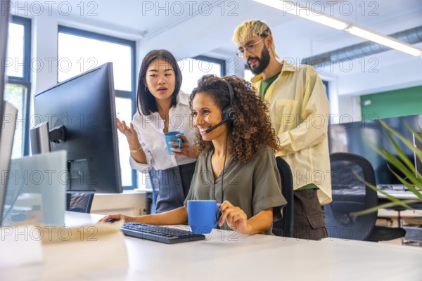 Coworkers drinking coffee while making a video call suing headset