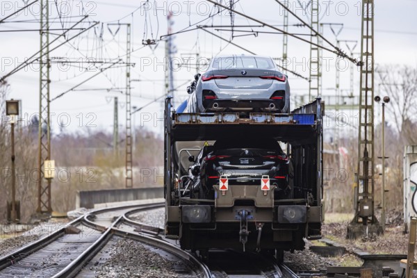 Goods train travelling on the winding Schuster Railway, overhead lines and infrastructure. Car transport with new BMW cars. Stuttgart, Baden-Württemberg, Germany, Europe