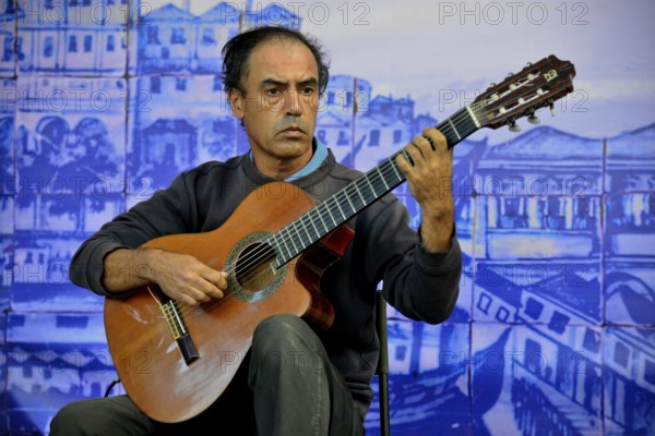 Fado musician performing at a concert in Castelo de Sao Jorge Castle, Alfama, Lisbon, Lisbon District, Portugal, Europe