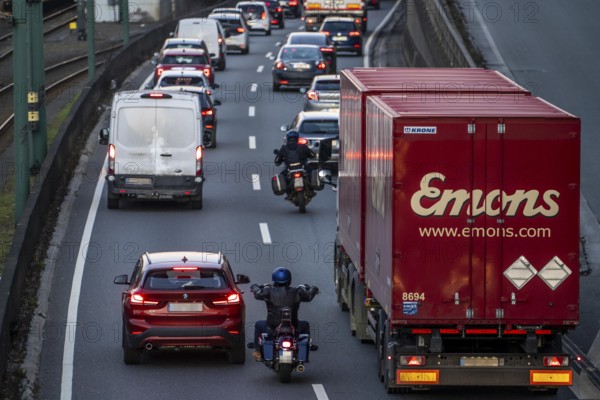 Motorcyclists overtake the partly stationary, partly slow-moving traffic in the middle of the carriageway in a traffic jam on the A40 motorway, North Rhine-Westphalia, Germany, Europe