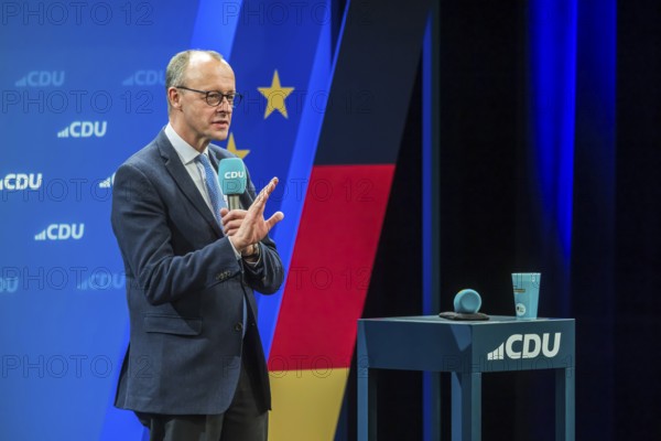 Election event of the CDU party for the Bundestag elections with top candidate Friedrich Merz. Portrait in front of the German flag and the flag of the European Union. Singen am Hohentwiehl. Baden-Württemberg, Germany, Europe