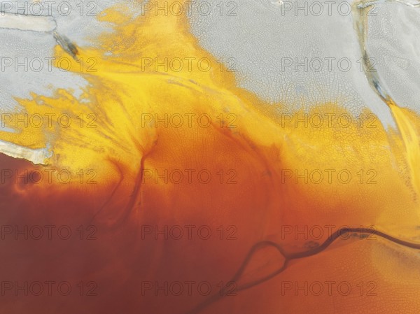 Waste pond in the mineral-rich area of the Rio Tinto mines. The colour is caused by oxidised iron minerals. Aerial view. Drone shot. Huelva province, Andalusia, Spain, Europe