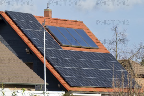 Weathercock in front of a house roof with photovoltaics, Kamen, North Rhine-Westphalia, Germany, Europe