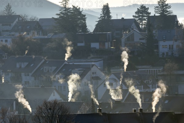 Roofs with smoking chimneys on a cold winter morning, Korb im Remstal, Baden-Württemberg, Germany, Europe