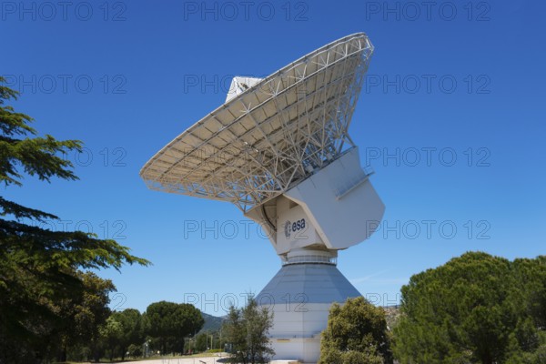 ESA's large radio telescope under a clear blue sky, surrounded by green trees, for scientific use, European Space Astronomy Centre, Villafranca del Castillo, Madrid, Spain, Europe