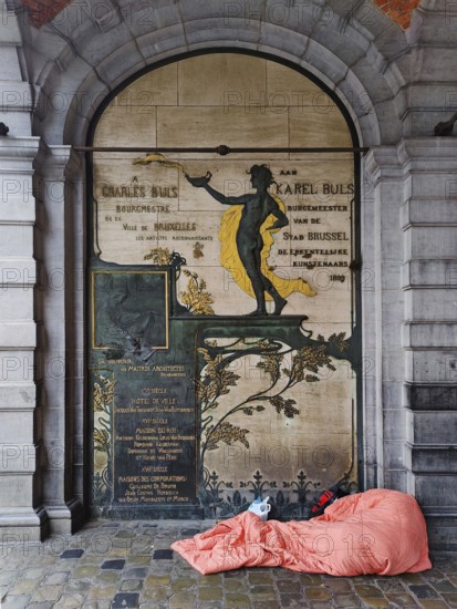 Homeless person in front of a façade detail at the L'Étoile guildhall, Grand-Place, Grote Markt, Brussels, Belgium, Europe