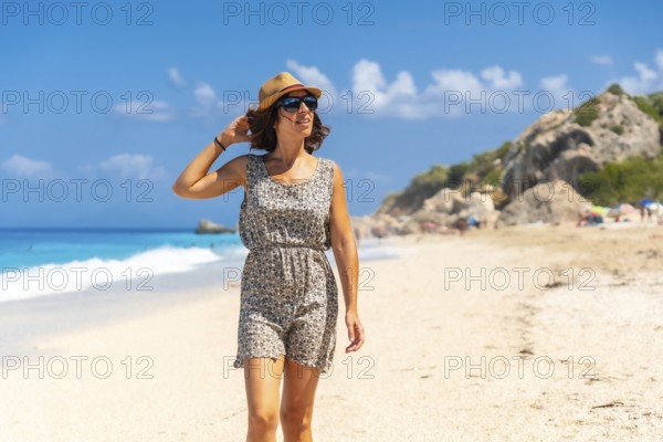 Woman enjoying summer at Megali Petra beach with turquoise water of Lefkada island, Ionian Sea, Greece, Europe