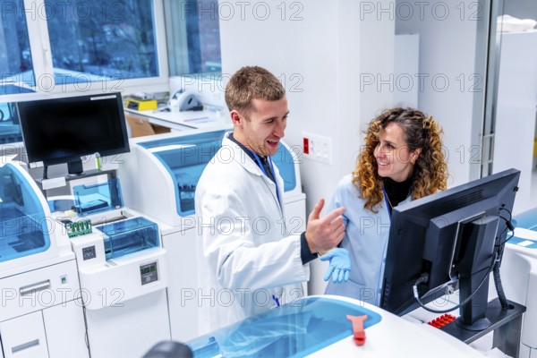 Young scientists working using computer in a modern laboratory of an hospital in the pathology area