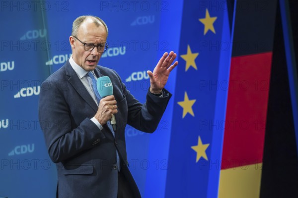 Election event of the CDU party for the Bundestag elections with top candidate Friedrich Merz. Portrait in front of the German flag and the flag of the European Union. Singen am Hohentwiehl. Baden-Württemberg, Germany, Europe