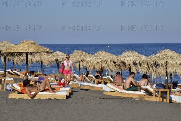 Tourists on Perívolos Beach near Perivolos, Perívolos, Santorin, Cyclades, Greece, Europe
