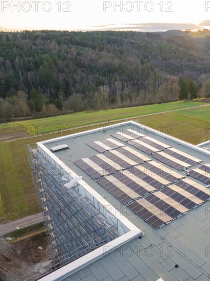 Building roof with solar panels next to agricultural fields and a forest, new Calw health campus, Calw district, Black Forest, Germany, Europe