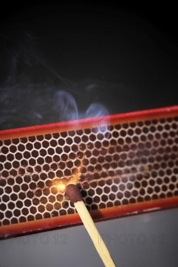 Striking a match against a match box