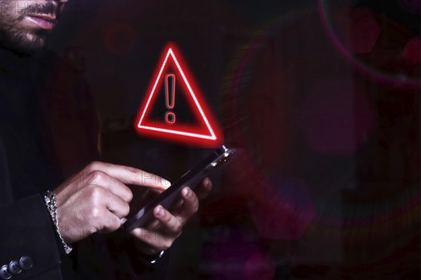 Hacker control and spying on your mobile phone. Symbol of caution in the use of cell phones.
