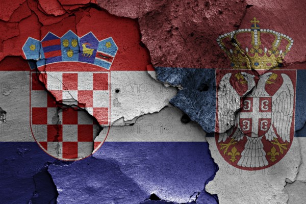 Flags of Croatia and Serbia painted on cracked wall