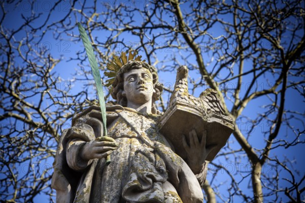 An angel in front of the abbey church St. Stephanus and St. Vitus, Abbey Castle Corvey in Hoexter, Weserbergland, North Rhine Westphalia, Germany, Europe