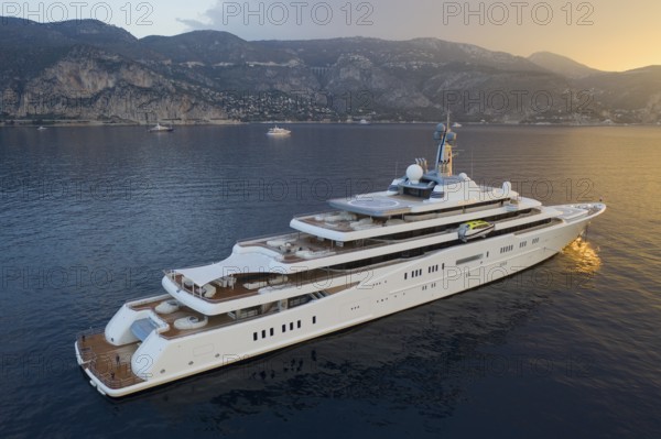Aerial view 162, 5 metre long motor yacht ECLIPSE, delivered in 2010 by the Hamburg shipyard Blohm & Voss to the Russian oligarch Roman Abramovich, designer Terence Disdale, until 2013 the largest yacht in the world, at anchor at sunrise in the bay of Beaulieu-sur-Mer near Cap Ferrat, French Riviera, France, Mediterranean Sea, Europe