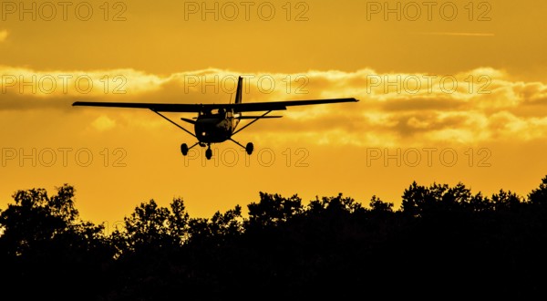 Cessna 172 approaching in the sunset