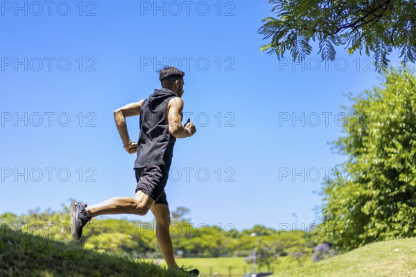A man jogging on hilly trails in a serene natural park