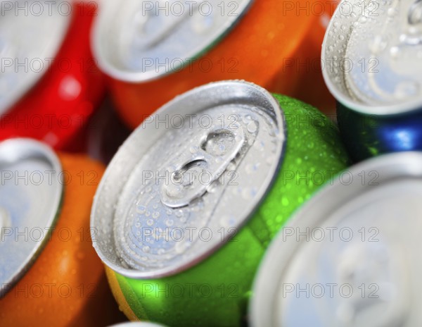 Cans of sweet drinks (or beer) . Cooling frozen and with water drops