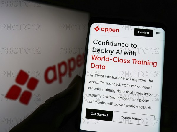 Stuttgart, Germany, 05-26-2022: Person holding smartphone with webpage of Australian data company Appen Limited on screen in front of logo. Focus on center of phone display, Europe