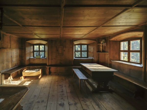 Farmhouse parlour with a small house altar in the dining corner and a baby cot, open-air museum "Museum Tiroler Bauernhöfe", Kramsach, Kufstein District, North Tirol, Tirol, Austria, Europe