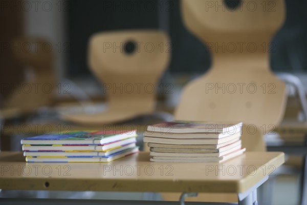School furniture with textbooks in an empty classroom. Bavaria, Germany, Europe