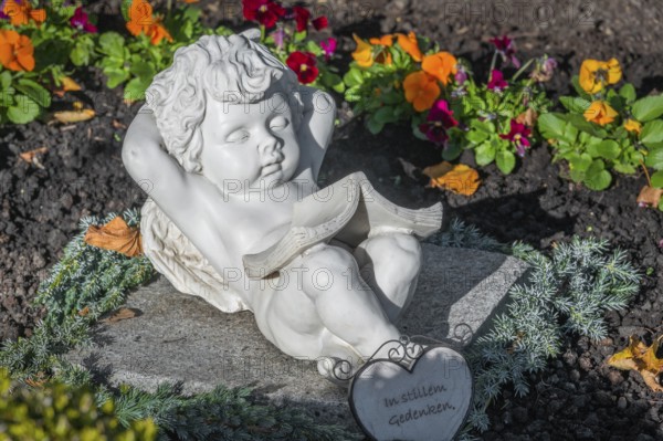 Grave with sleeping cherub near the rococo church of St Ulrich, affectionately known as -the little meadow-, Seeg, Allgäu, Bavaria, Germany, Europe