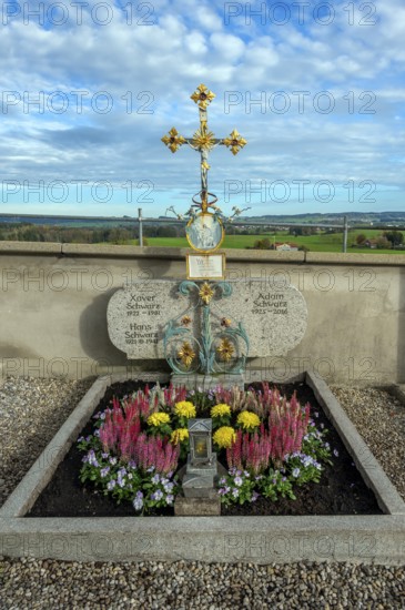 Grave with heather (Erica), near St George and St Florian, a listed Catholic parish church in Reicholzried, Allgäu, Bavaria, Germany, Europe