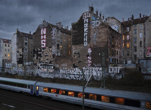 Germany, Berlin, 17.12.2024, View from Schönfließer Brücke, rear building gable Kopenhagener Straße, regional train, Europe