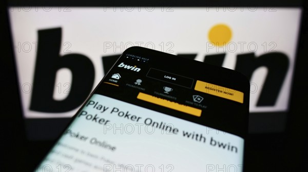 Stuttgart, Germany, 01-08-2022: Mobile phone with webpage of sports betting company bwin Interactive Entertainment on screen in front of logo. Focus on top-left of phone display, Europe
