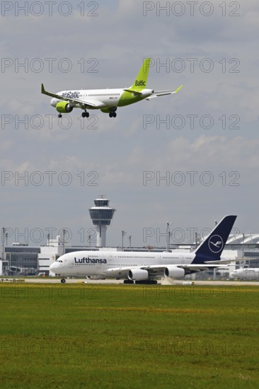 Lufthansa Airbus A380-800 with control tower waiting for take-off clearance for southern runway with landing Air Baltic Airbus A320, Munich Airport, Upper Bavaria, Bavaria, Germany, Europe