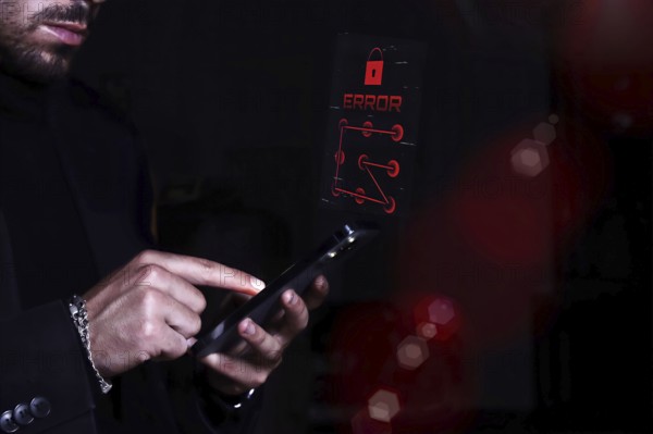 A man in a dark suit troubleshooting a system error on his digital tablet.