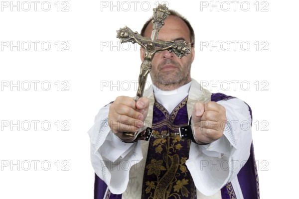 A Catholic priest with handcuffs as a symbol of child abuse. Austria